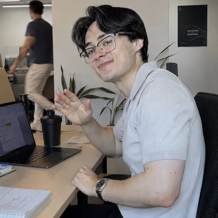 Isaac waving from his desk at the marketing agency he used to work at
